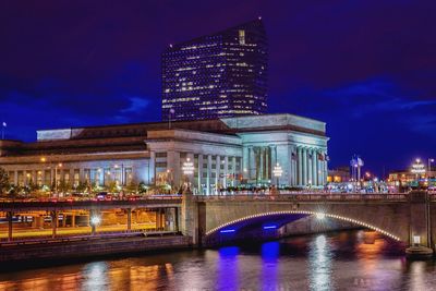 Bridge and building in city lit up at night