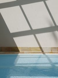 View of swimming pool by window