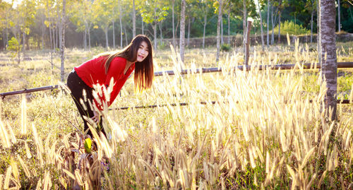 Portrait of smiling young woman on field