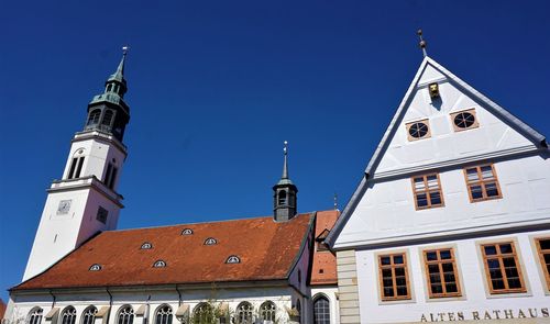 Low angle view of building against clear blue sky