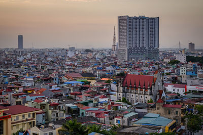 High angle view of buildings in city against sky during sunset