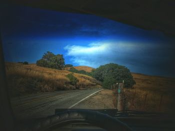 Scenic view of landscape against blue sky