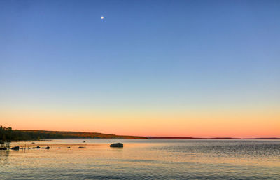 Scenic view of sea against clear sky during sunset