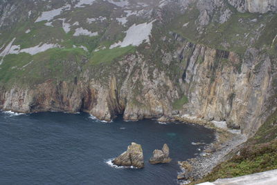 High angle view of rocks by sea