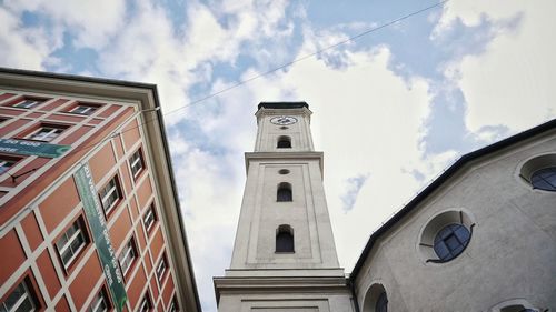 Low angle view of bell tower against cloudy sky