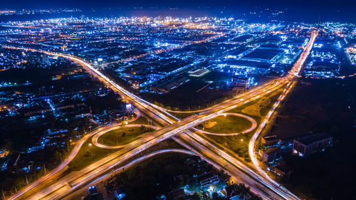 Aerial view interchange ring road and motorway freeway highways and moving headlight cars 