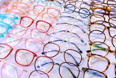 High angle view of multi colored eyeglasses on table at stall