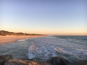 Scenic view of sea against clear sky during sunset