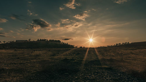 Scenic view of field against sky during sunset