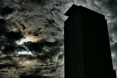 Low angle view of building against cloudy sky