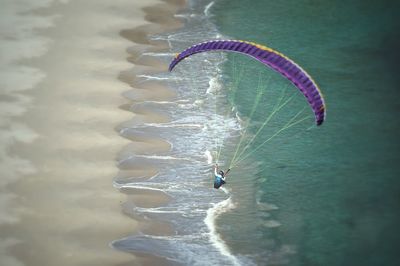 Person paragliding in water