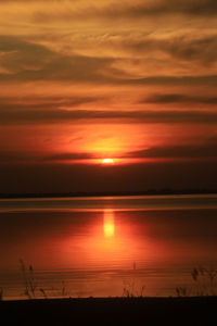 Scenic view of sea against orange sky