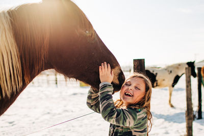 Portrait of smiling woman with horse