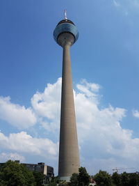 Low angle view of communications tower against sky