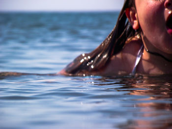 Low section of woman in swimming pool