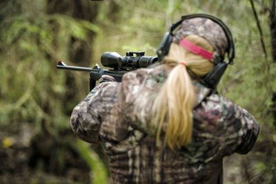 Woman hunting in forest