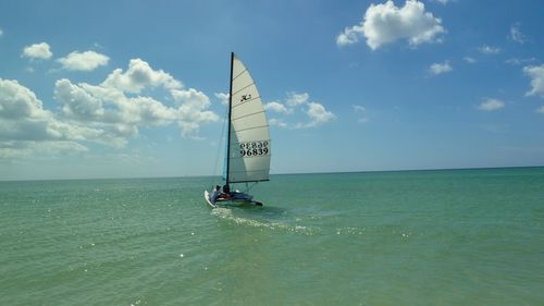 Sailboat on sea against sky