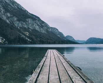 Scenic view of lake by mountains against sky