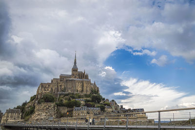 Low angle view of historic building against cloudy sky