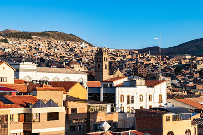 High angle view of townscape against clear blue sky