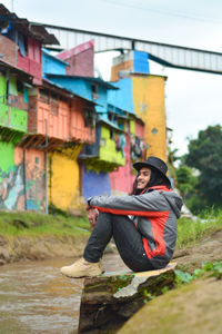 Man sitting on bridge
