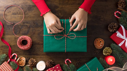 Directly above shot of girl packing christmas gift