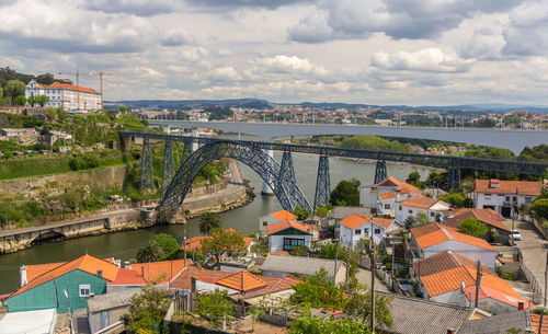High angle view of river by townscape against sky