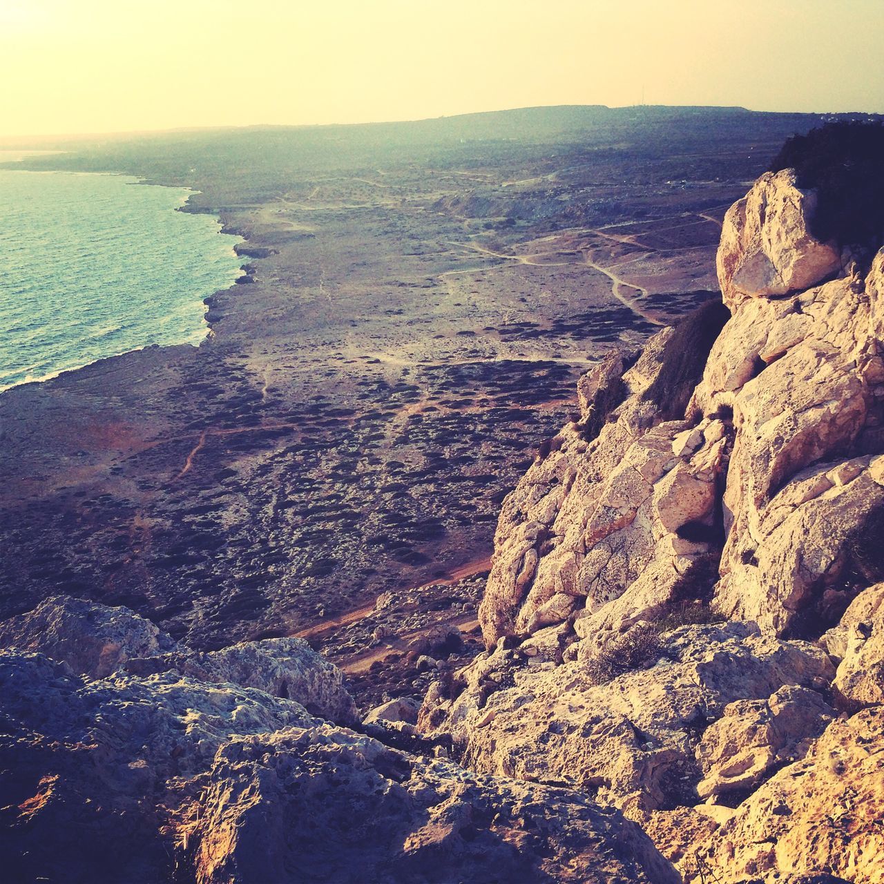 sea, water, tranquil scene, scenics, tranquility, beauty in nature, horizon over water, nature, idyllic, coastline, beach, high angle view, sky, remote, shore, outdoors, mountain, rock formation, no people, non-urban scene