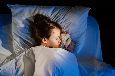 High angle view of baby sleeping on bed