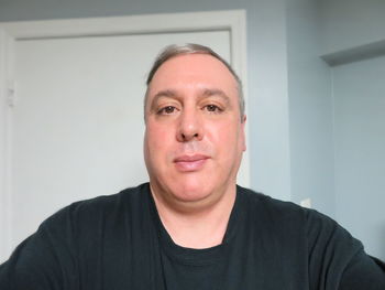 Portrait of man against wall at home