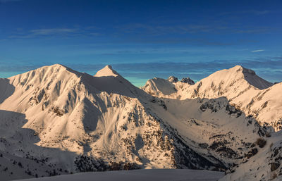 Scenic view of snowcapped mountains against sky