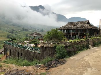 Houses by mountains against sky