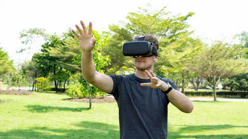 Man wearing virtual reality simulator while gesturing on field