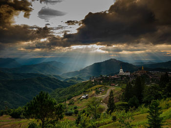 Panoramic view of trees and buildings against sky