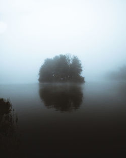 Reflection of trees in lake against sky