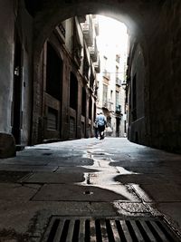 High angle view of man walking in narrow alley