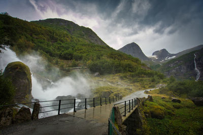 Scenic view of waterfall against sky