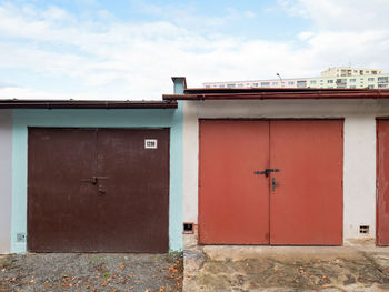 Old rusty garage doors in row. long building for cars parking close to town.