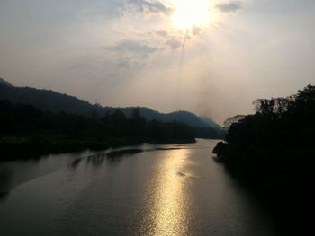 Scenic view of river against sky during sunset