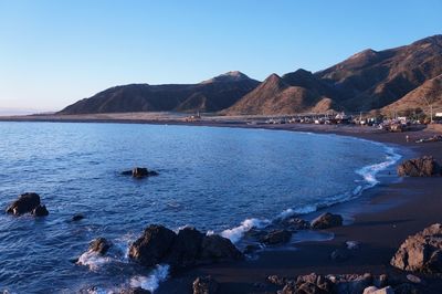 Scenic view of sea with mountains in background