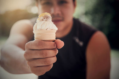 Midsection of man holding ice cream