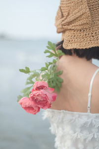 Low section of woman with pink roses