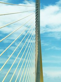 Low angle view of suspension bridge against sky