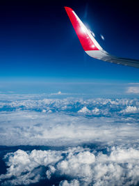 Aerial view of airplane wing against sky