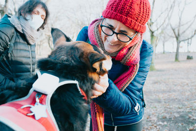 Smiling woman petting dog