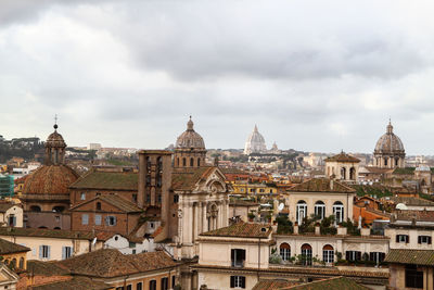 Panorama over the roofs, churches and monuments of rome, cloudy sky.