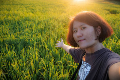 Portrait of teenage girl on field