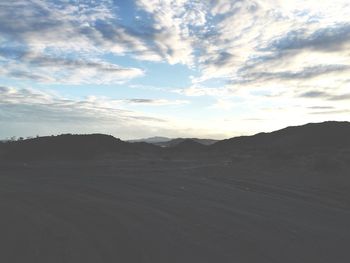 Scenic view of landscape against cloudy sky