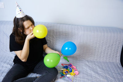 Children have fun playing, blowing up colorful balloons, at a birthday party