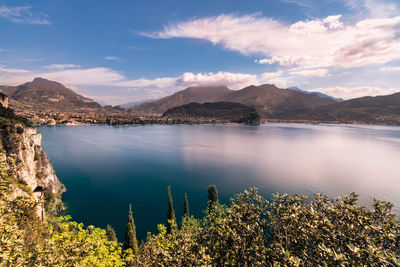 Scenic view of lake by mountains against sky